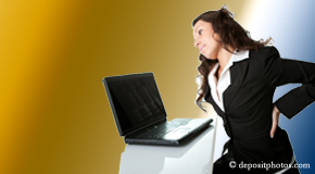 a person Easley bending over a computer holding her back due to pain